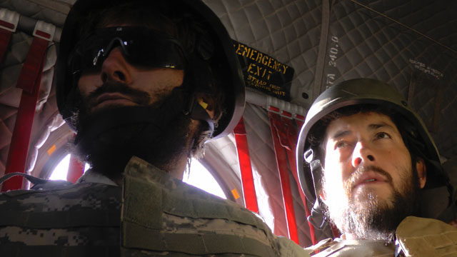 Former Former journalist Matthew VanDyke and Daniel Britt in a helicopter in Afghanistan