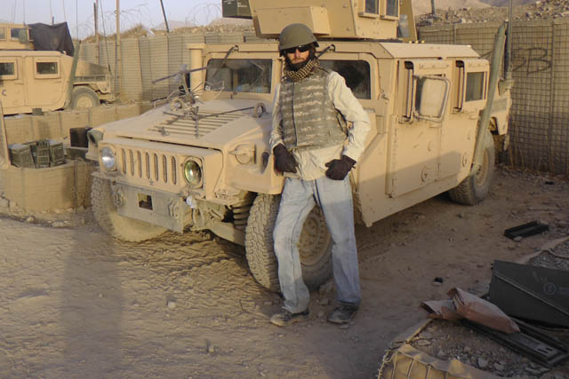 Former Former journalist Matthew VanDyke next to a Humvee at FOB Baylough in Afghanistan