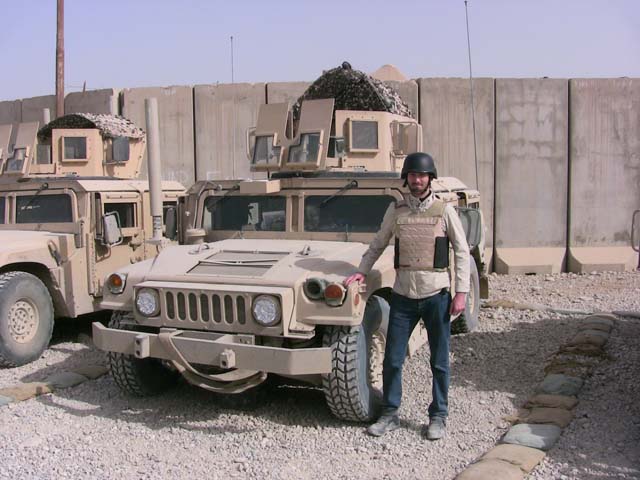 Former journalist Matthew VanDyke next to a Humvee in Mosul Iraq