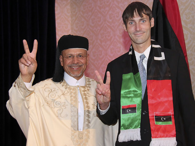 Matthew VanDyke with Libyan Ambassador Ali Aujali at an awards ceremony in the United States after the Libya civil war