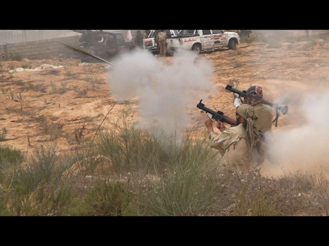 Freedom fighter Matthew VanDyke firing a RPG during combat in Sirte Libya