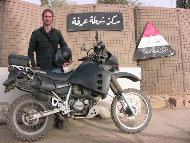 Matthew VanDyke with his Kawasaki KLR650 motorcycle at a Kirkuk police station following his detainment in Kirkuk Iraq