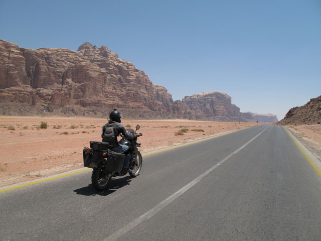 Matthew VanDyke driving his Kawasaki KLR650 motorcycle in Wadi Rum Jordan