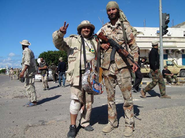Freedom fighter Matthew VanDyke with famous Libyan revolution singer Massoud Abu Assir in Sirte Libya