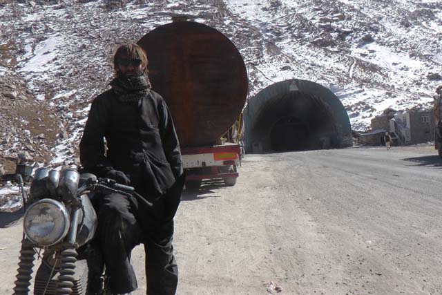 Matthew VanDyke with his MZ Kanuni motorcycle at the Salang Pass tunnel in Afghanistan