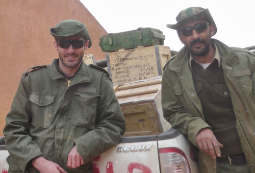 Matthew VanDyke and Nouri Fonas with ammunition they acquired from Rajma Libya