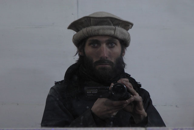 Matthew VanDyke undercover as an Afghan with pakul hat and his Panasonic HDC TM700 video camera in Afghanistan