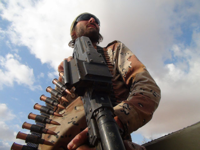 Freedom fighter Matthew VanDyke with a PKT machine gun
