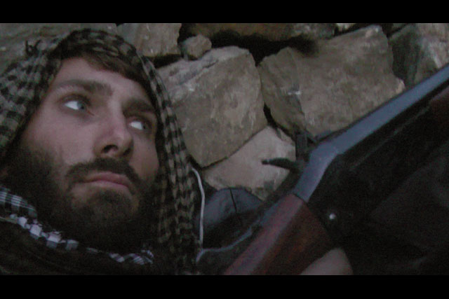 Matthew VanDyke with his sawed-off shotgun for self-defense in Afghanistan