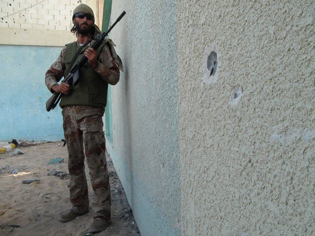 Freedom fighter Matthew VanDyke advancing on enemy positions in District 2 in Sirte, Libya
