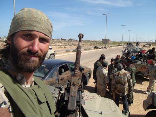 freedom fighter matthew vandyke in his kadbb military jeep with dshk machine gun in the libyan civil war