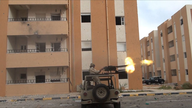 freedom fighter matthew vandyke firing his dshk machine gun in his kadbb military jeep in sirte libya during the libyan civil war