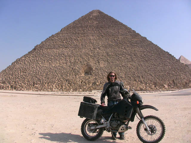 adventurer matthew vandyke with his kawasaki klr650 motorcycle in front of a pyramid in giza egypt